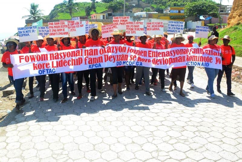 Group of protesters holding banners advocating for farmers' rights in Haiti.