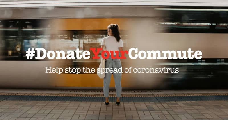 Woman at train station with #DonateYourCommute message to stop coronavirus spread.