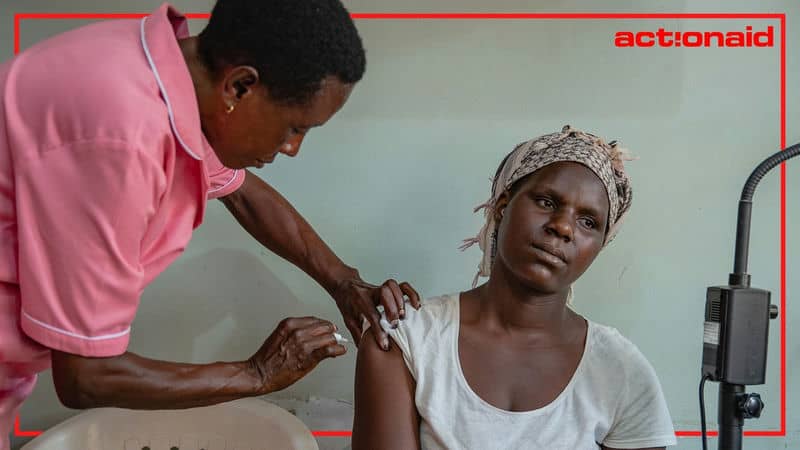 Healthcare worker administering vaccine to a woman, highlighting vaccination efforts.