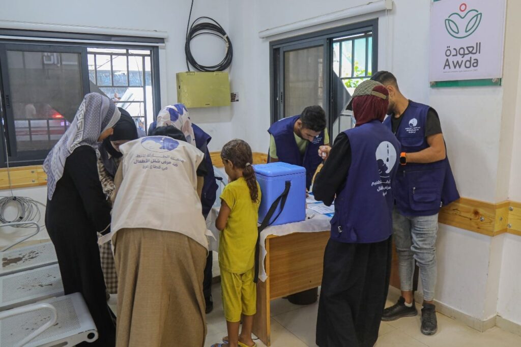 Healthcare workers assisting children at a clinic, featuring activity and collaboration in a medical setting.