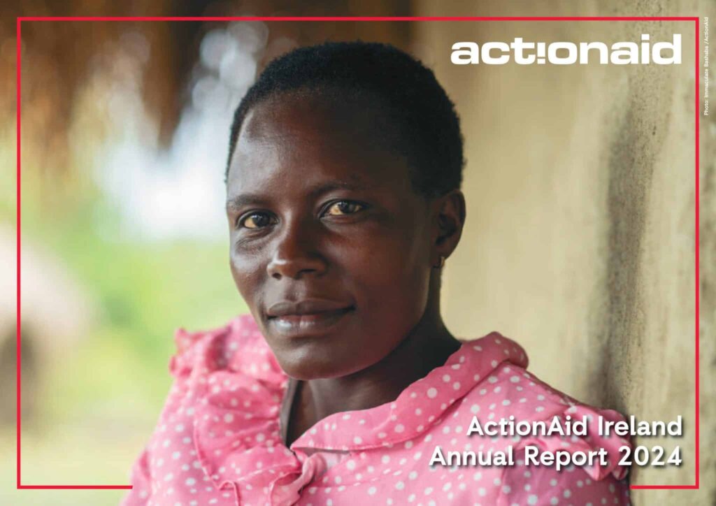 Smiling woman in pink with natural background for ActionAid Ireland Annual Report 2024 cover.