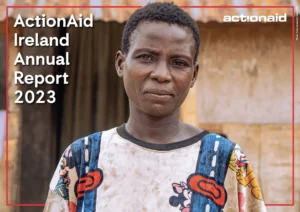 ActionAid Ireland 2023 Report cover featuring a woman in a colorful shirt standing in front of a rustic backdrop.