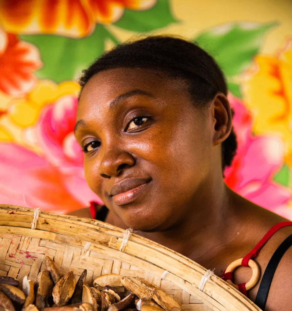 Woman holding a basket of nuts, vibrant floral background, celebrating local produce and culture.