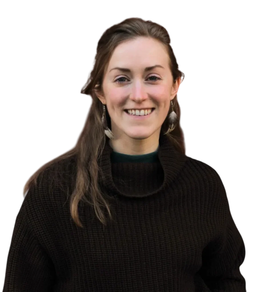 Smiling woman in a black sweater with long hair and earrings, isolated on white background.